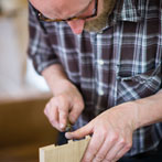 Ben Casson making a shelving unit in his workshop at Wobage Farm 2016